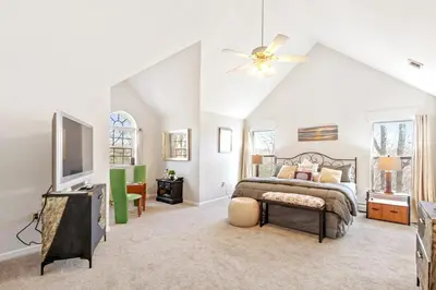a bedroom with a bed and a ceiling fan at Hilltop Villa in East Stroudsburg