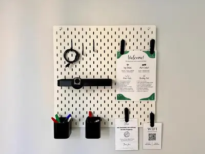 a wall with a pegboard with pens and a clock at Spacious Center City 3BR 4BA with Arcade - Sleeps 8 in Philadelphia