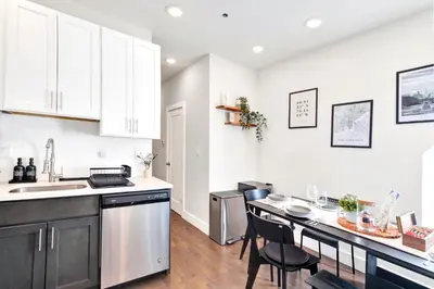a kitchen with white cabinets and a counter top at Spacious Center City 3BR 4BA with Arcade - Sleeps 8 in Philadelphia