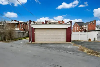 a garage door in a driveway in front of houses at Downtown Lancaster Luxury 4BR - Garage & Parking in Lancaster