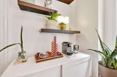 a room with a counter with a coffee maker and plants at Downtown Lancaster Luxury 4BR - Garage & Parking in Lancaster