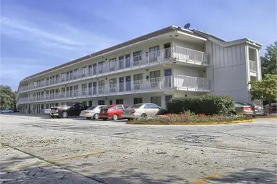 a large building with cars parked in a parking lot at Cumberland Inn By OYO New Cumberland-Hershey South in New Cumberland