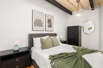 a bedroom with a large bed and a mirror at Beautifully designed 3 BDR in Dumbo NYC in Brooklyn