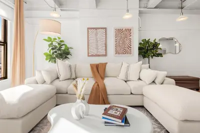 a living room with a white couch and a table at Beautifully designed 3 BDR in Dumbo NYC in Brooklyn