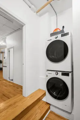 a microwave sitting on top of a washing machine in a room at Beautifully designed 3 BDR in Dumbo NYC in Brooklyn