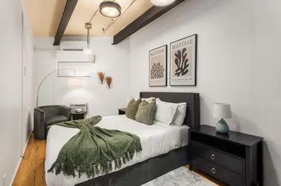 a bedroom with a bed and a chair at Beautifully designed 3 BDR in Dumbo NYC in Brooklyn
