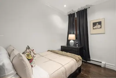 a living room with a couch and a table at Explore NYC! Cozy 2BR in Prime Location in New York