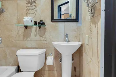 a bathroom with a white toilet and a sink at NYC Premier Walking Distance to Times Square in New York