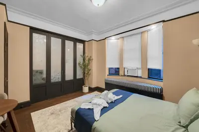 a bedroom with a bed with towels on it at NYC Premier Walking Distance to Times Square in New York