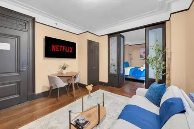 a living room with a couch and a table at NYC Premier Walking Distance to Times Square in New York