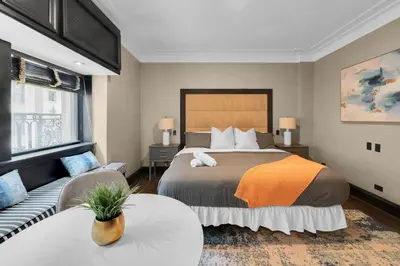 a bedroom with a large bed and a couch at NYC Apartment in The Best Location! Walking Distance to Everything! in New York