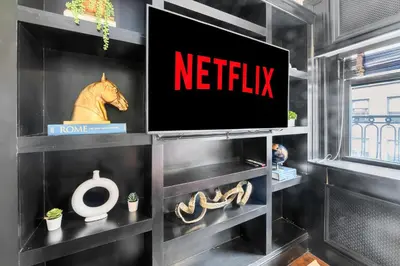 a netflix sign on a wall in a room at NYC Apartment in The Best Location! Walking Distance to Everything! in New York
