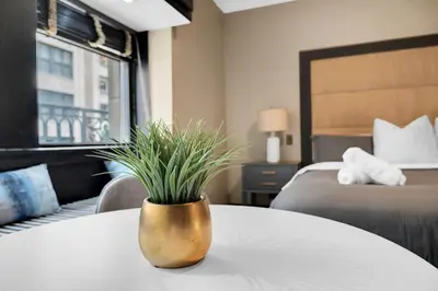 a vase with a plant on a table in a hotel room at NYC Apartment in The Best Location! Walking Distance to Everything! in New York