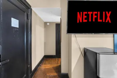 a sign that says netflix on a wall in a hallway at NYC Apartment in The Best Location! Walking Distance to Everything! in New York