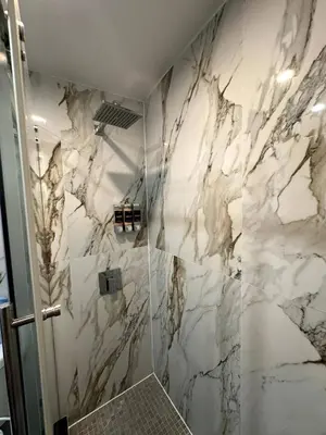 a bathroom with marble walls and a shower at The Gray Loft Escape NYC Edition. in New York