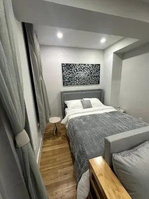 a bedroom with a large bed in a room at The Gray Loft Escape NYC Edition. in New York
