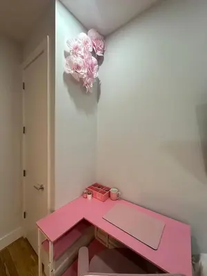 a pink table with a pink flower on a wall at The Gray Loft Escape NYC Edition. in New York