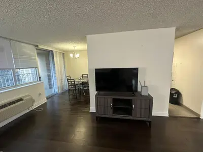 a living room with a flat screen tv on a entertainment center at 1500 Locust Apartments Luxury Living in the Heart of Philadelphia in Philadelphia