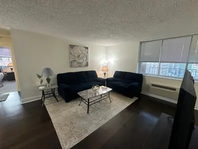 a living room with a couch and a table at 1500 Locust Apartments Luxury Living in the Heart of Philadelphia in Philadelphia