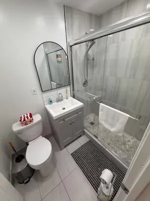 a bathroom with a shower and a toilet and a sink at Fireflies In NYC, Cozy, Private & New in Union City