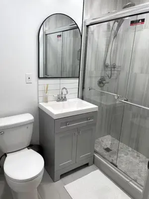 a bathroom with a toilet sink and a shower at Fireflies In NYC, Cozy, Private & New in Union City