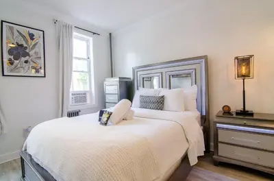 a bedroom with a large bed and a window at Fireflies In NYC, Cozy, Private & New in Union City