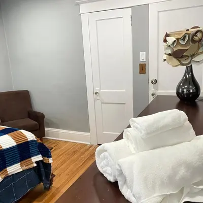 a room with a table and a chair and towels at Rehan in Teaneck