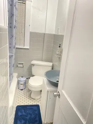 a bathroom with a toilet and a sink at Rehan in Teaneck