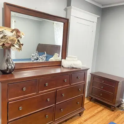 a dresser with a mirror on top of it at Rehan in Teaneck