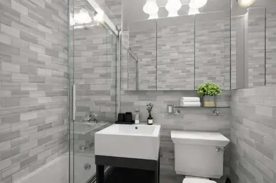 a bathroom with a toilet and a sink and a shower at Sophisticated Stay in Vibrant Manhattan in New York