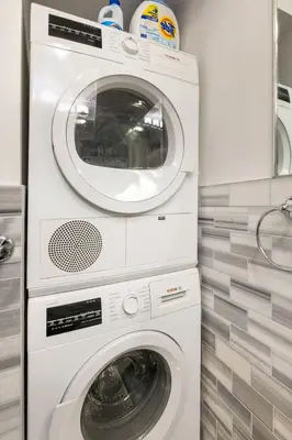 a white washer and dryer in a kitchen at Sophisticated Stay in Vibrant Manhattan in New York