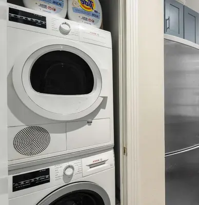 a washer and dryer in a corner of a room at Modern Manhattan Haven Near Everything in New York