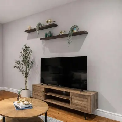 a living room with a large television and a table at Modern Manhattan Haven Near Everything in New York