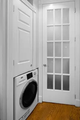 a washing machine in a room with a door at Modern Manhattan Stay in Prime Spot in New York