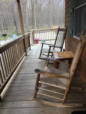 two rocking chairs on a porch of a cabin at Secluded Cabin Nestled in the Mountains near the Tioga State Forest, Pennsylvania in Blossburg
