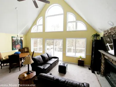 a living room with a couch and a table at Rustic Getaway Surrounded by Enchanting Forest near Philadelphia, Pennsylvania in Jim Thorpe