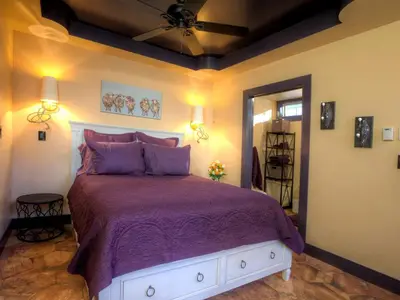 a bedroom with a large bed with purple sheets at Romantic Cottage Rental Tucked Away in the Countryside near Lancaster, Pennsylvania in Columbia