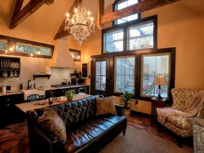 a living room with a leather couch and a kitchen at Romantic Cottage Rental Tucked Away in the Countryside near Lancaster, Pennsylvania in Columbia