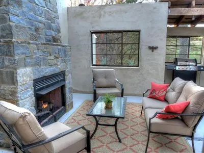 a living room with a stone fireplace and chairs at Romantic Cottage Rental Tucked Away in the Countryside near Lancaster, Pennsylvania in Columbia