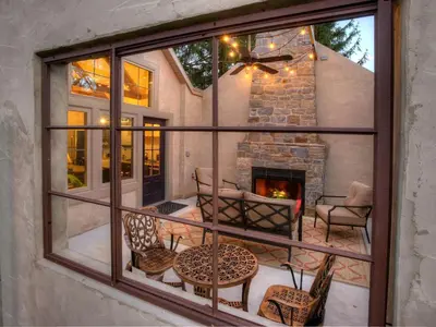a screened in porch with a fireplace and chairs at Romantic Cottage Rental Tucked Away in the Countryside near Lancaster, Pennsylvania in Columbia