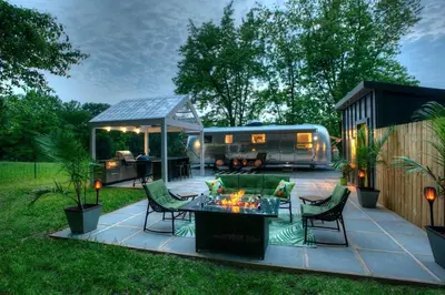 a backyard with a trailer and a table and chairs at Unique Accommodation for a Glamping Getaway in Columbia, Pennsylvania in Columbia