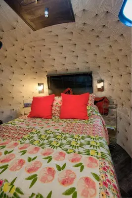a bedroom with a large bed with red pillows at Unique Accommodation for a Glamping Getaway in Columbia, Pennsylvania in Columbia