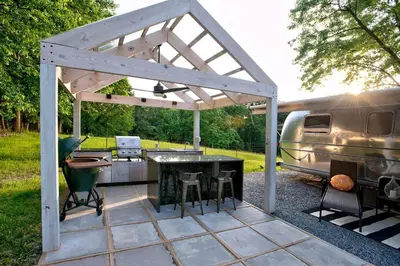 a pavilion with a grill and an rv parked at Unique Accommodation for a Glamping Getaway in Columbia, Pennsylvania in Columbia