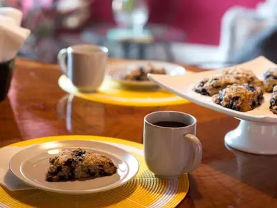 a table with plates of food and a cup of coffee at Modern Cottage Rental on a Peaceful Farm near Amish Country in Pennsylvania in Columbia