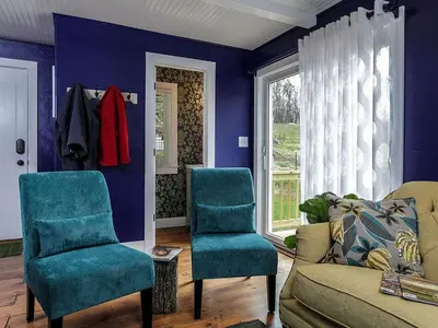 a living room with blue chairs and a couch at Elegant Farm Cottage Rental for a Countryside Getaway near Lancaster, Pennsylvania in Columbia