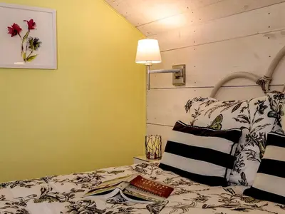 a bedroom with a bed with a book on it at Elegant Farm Cottage Rental for a Countryside Getaway near Lancaster, Pennsylvania in Columbia