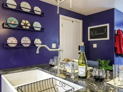 a kitchen with a sink and a bottle of wine at Elegant Farm Cottage Rental for a Countryside Getaway near Lancaster, Pennsylvania in Columbia