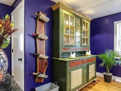 a kitchen with a green cabinet and purple walls at Elegant Farm Cottage Rental for a Countryside Getaway near Lancaster, Pennsylvania in Columbia