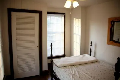 a bedroom with a bed and a window and a door at Idyllic Cottage Getaway on a Country Estate in Chester Springs, Pennsylvania in Chester Springs