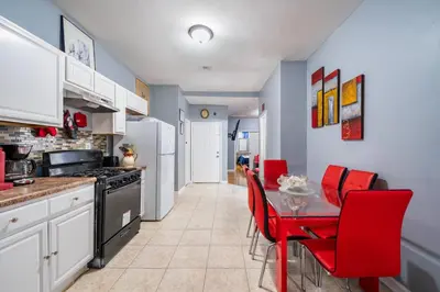 a kitchen with red chairs and a table in it at Newark 3BR Gem - Near NYC - & Attractions in Newark